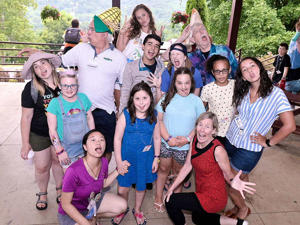 Stephen Chanock, Francis Collins, DCEG counselors, and campers pose for silly photo.