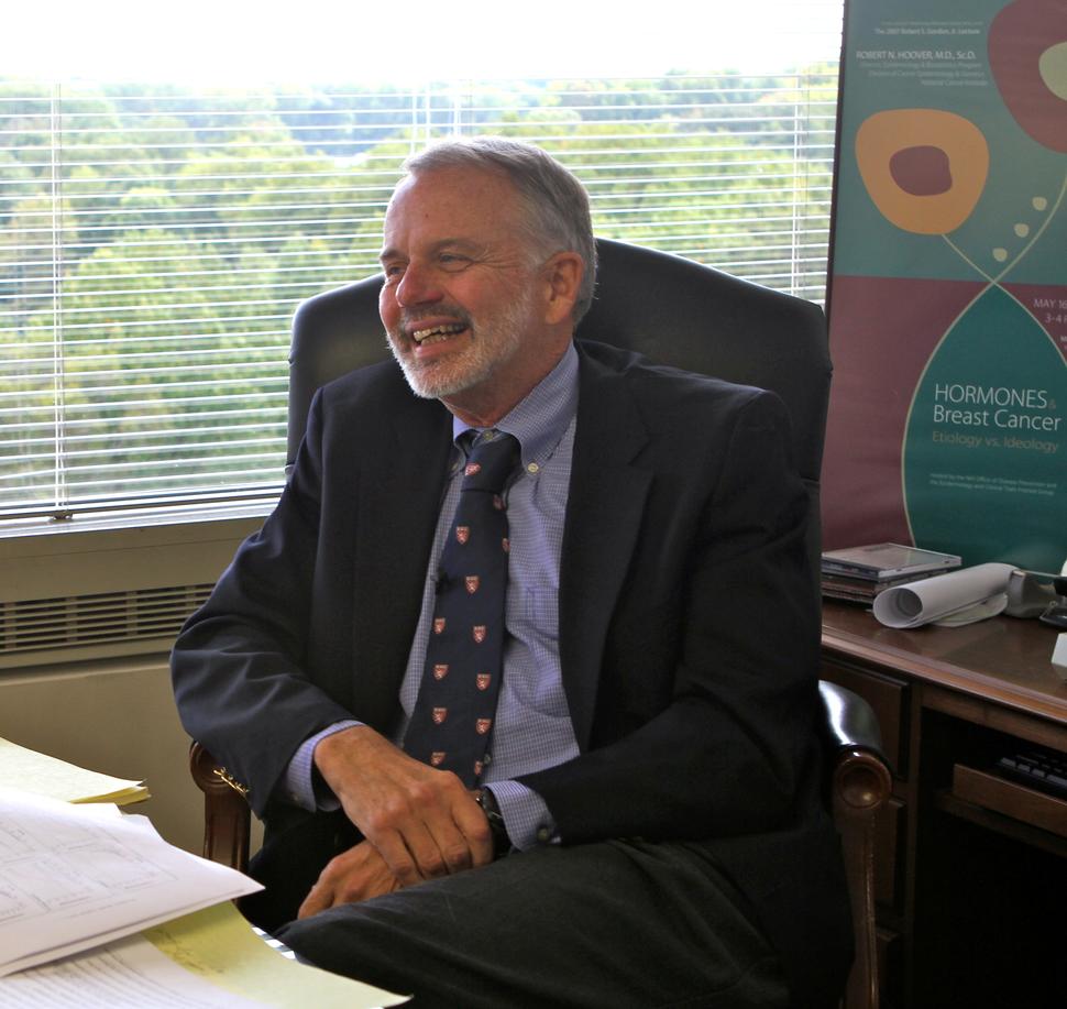 Photo of Robert Hoover sitting in office chair and laughing.