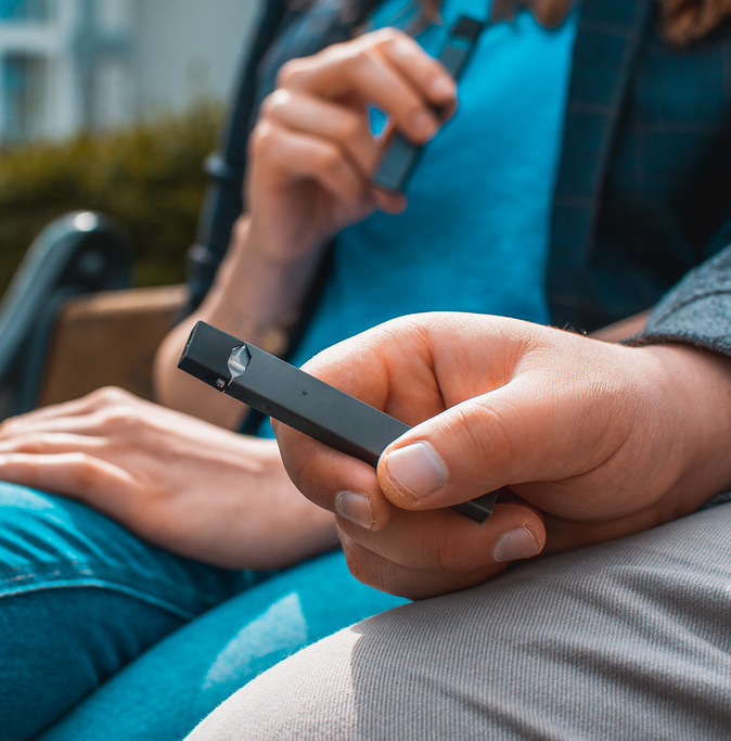 Image of a hand holding an electronic vape pen.
