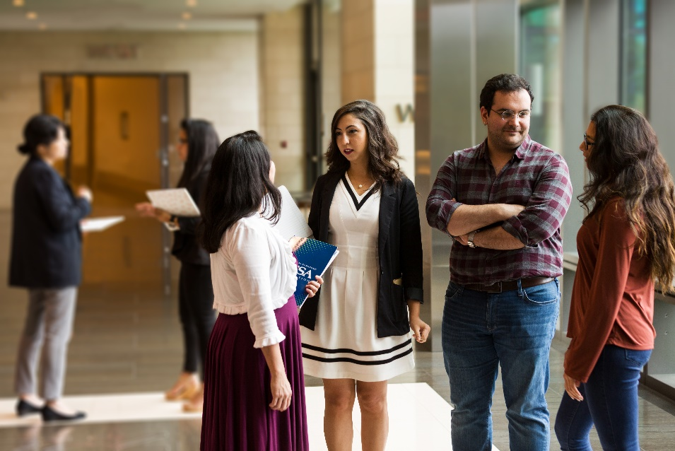 Photo of four fellows talking in a group