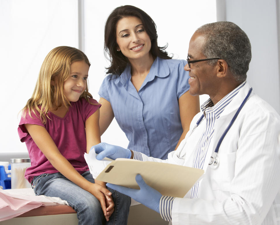 Image of a physician with a mother and her daughter.
