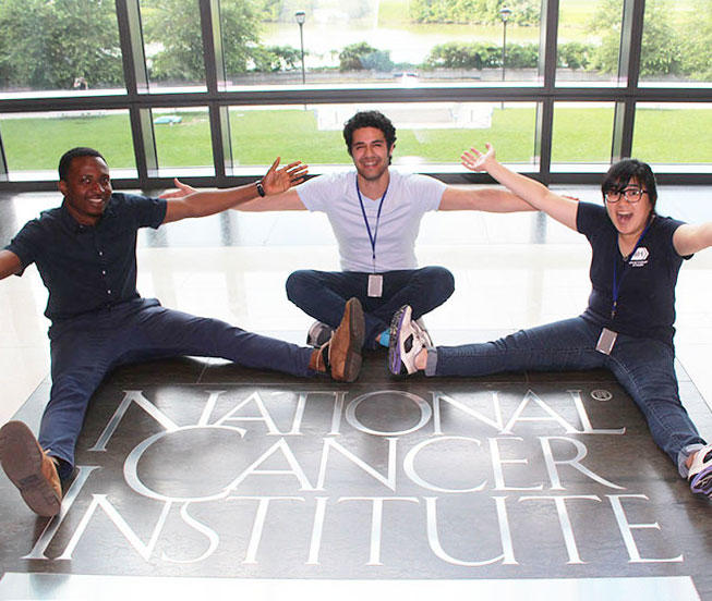 Summer interns of Dr. Prokunina-Olsson sitting on floor at NCI