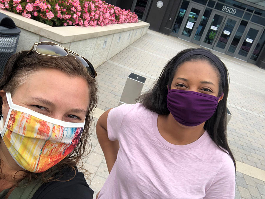 Selfie image of two masked women.