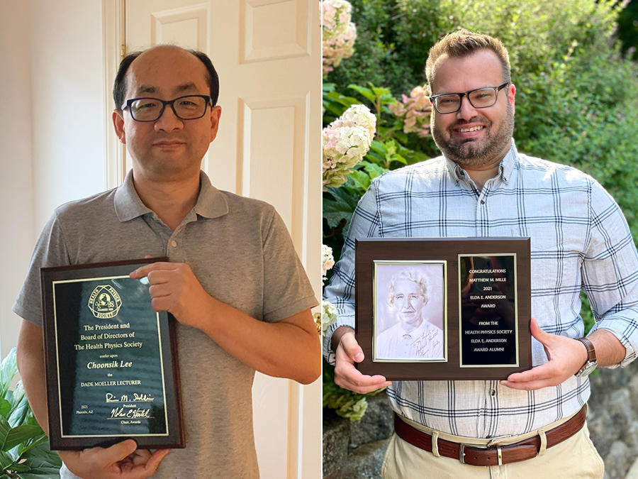 Choonsik Lee and Matthew Mille holding their award plaques.