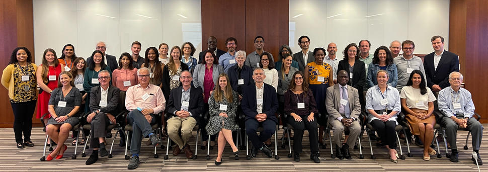 Attendees of the scientific workshop seated and standing