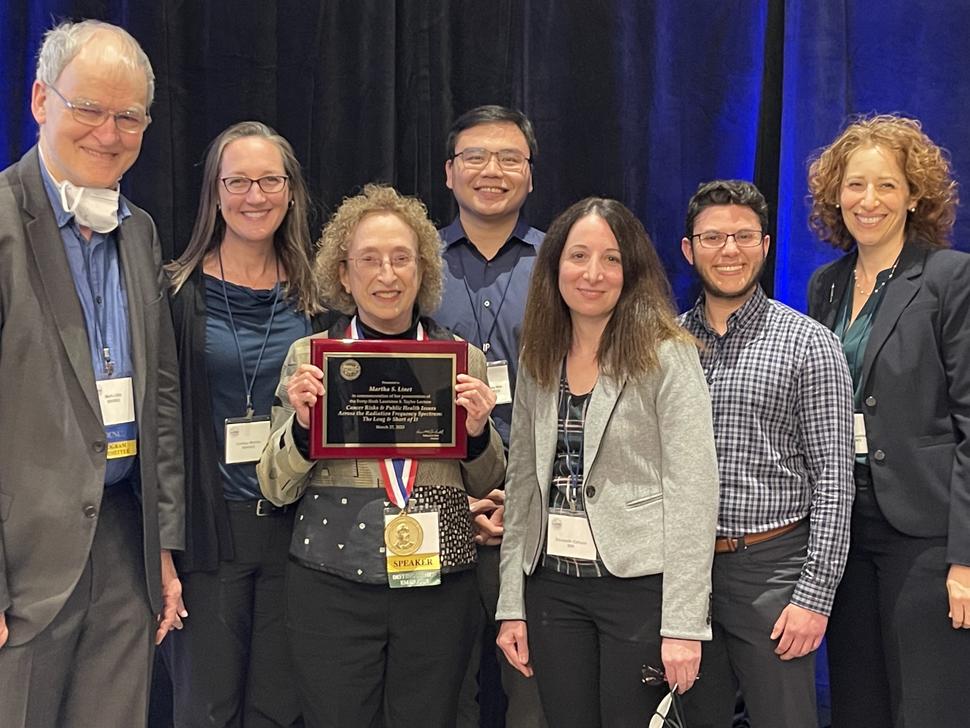 photograph of Dr. Linet with her award and DCEG staff