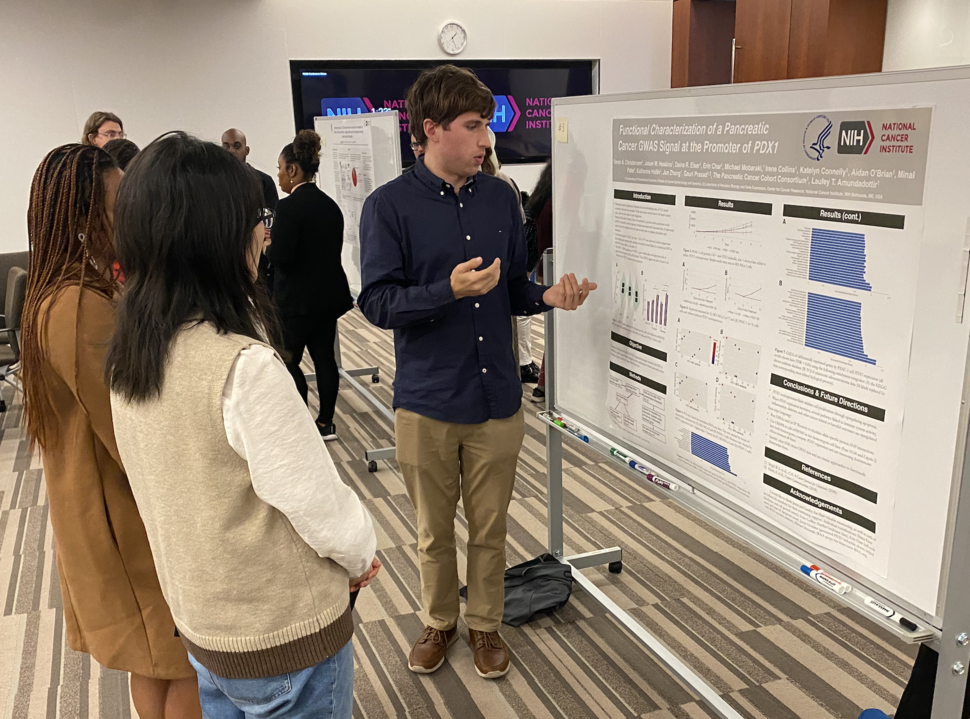 Trevor Christensen explains his poster to onlookers. 