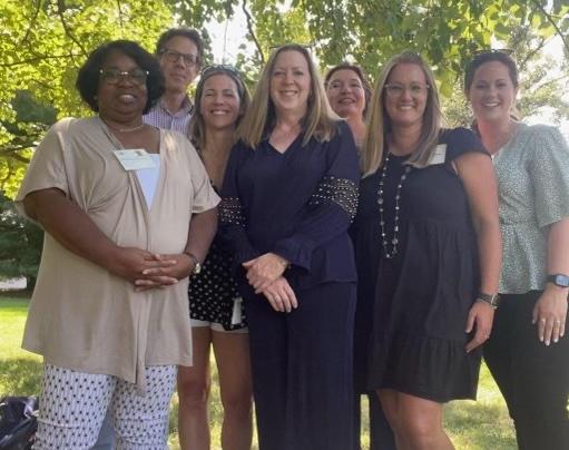photograph of a group of people standing outside
