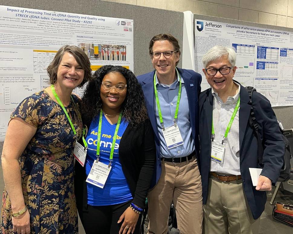 photograph of a small group of people at a poster