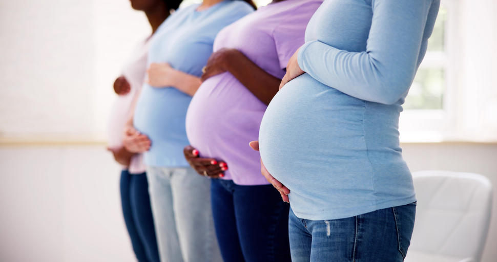 Photograph showing the profile of four pregnant bellies in a row