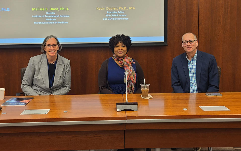 photograph of three people seated at a table