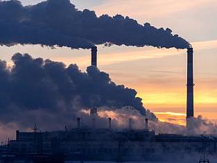 Emission to atmosphere from industrial factory chimney. Smokestack pipes shot with drone. Aerial view.