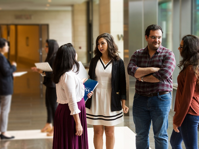 Photo of four fellows talking in a group