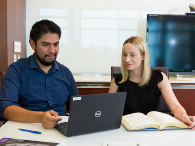 DCEG tenure-track investigators looking at a laptop screen