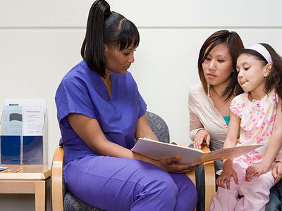 Doctor conferring with mother and daughter