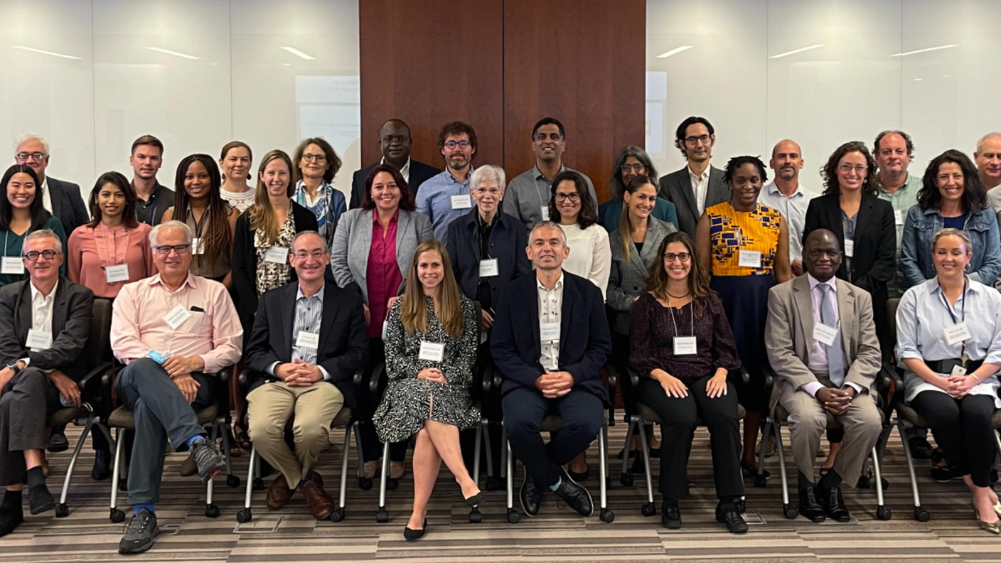 Attendees of the scientific workshop seated and standing