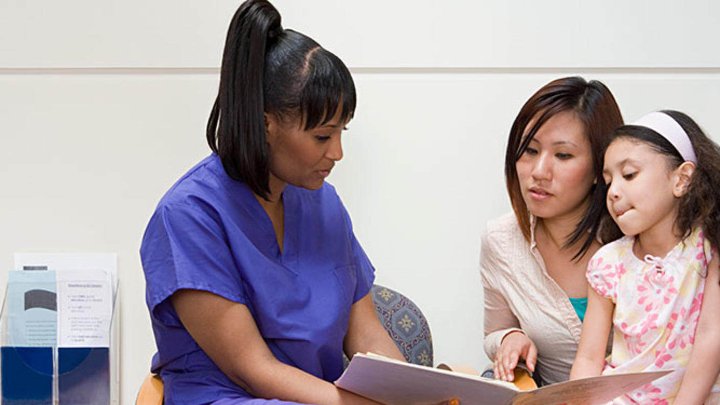 Doctor conferring with mother and daughter
