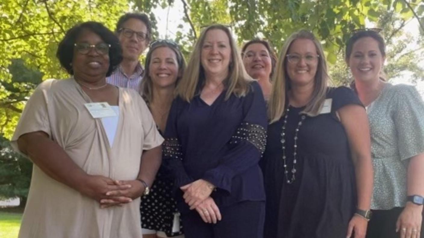photograph of a group of people standing outside