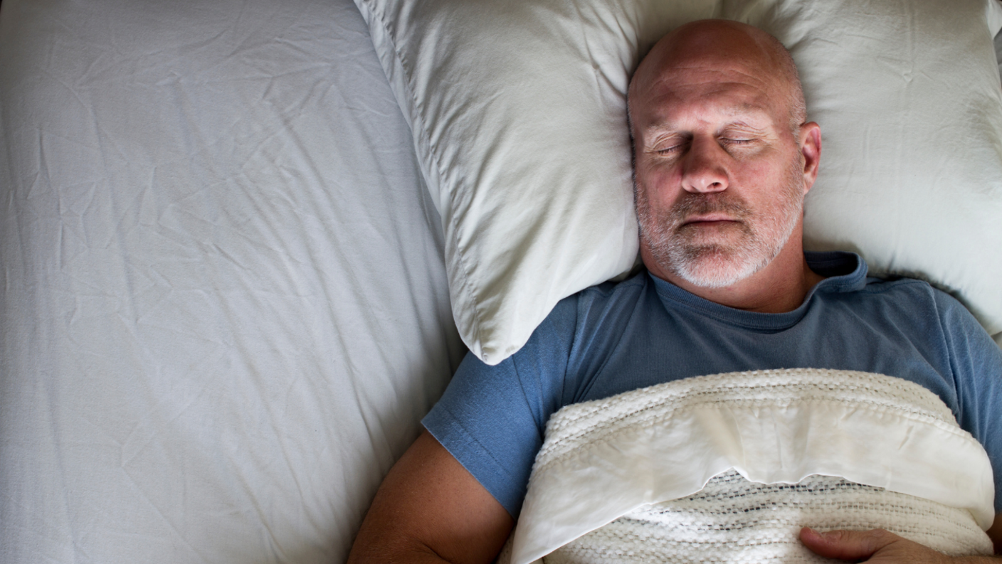 Older man sleeping on his back.