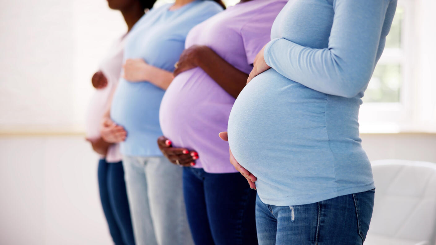 Photograph showing the profile of four pregnant bellies in a row