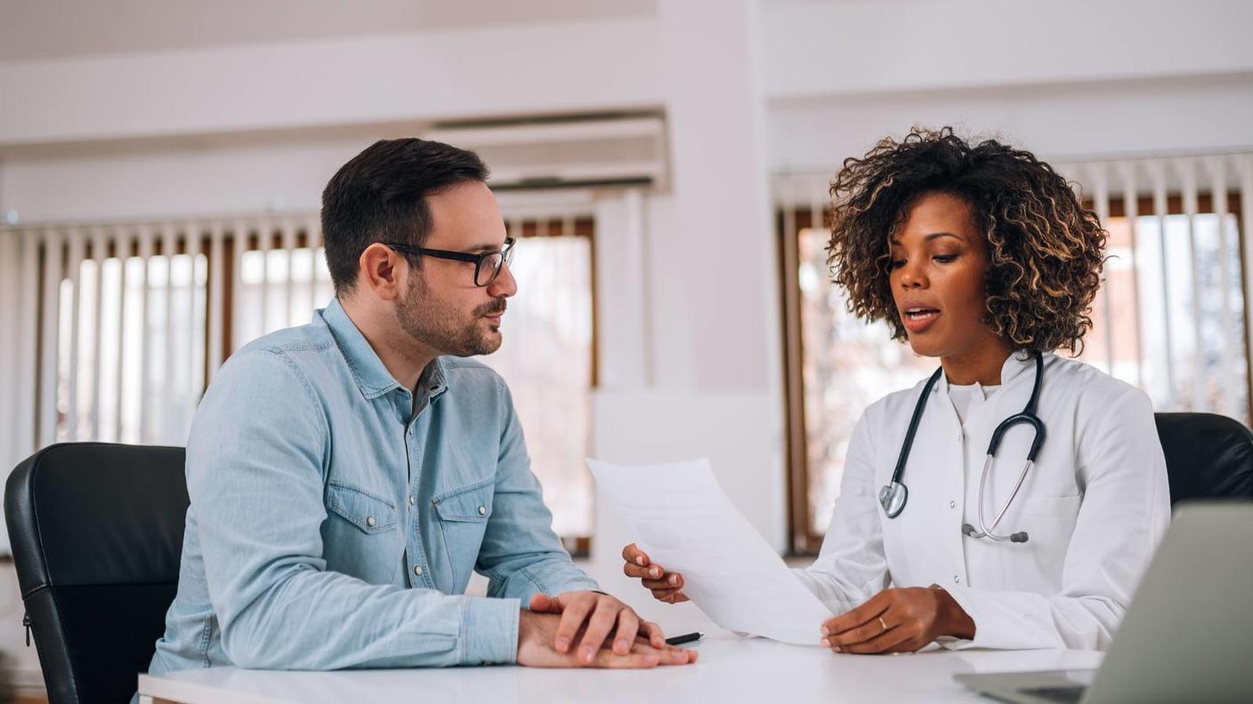 photo of doctor with patient reviewing information