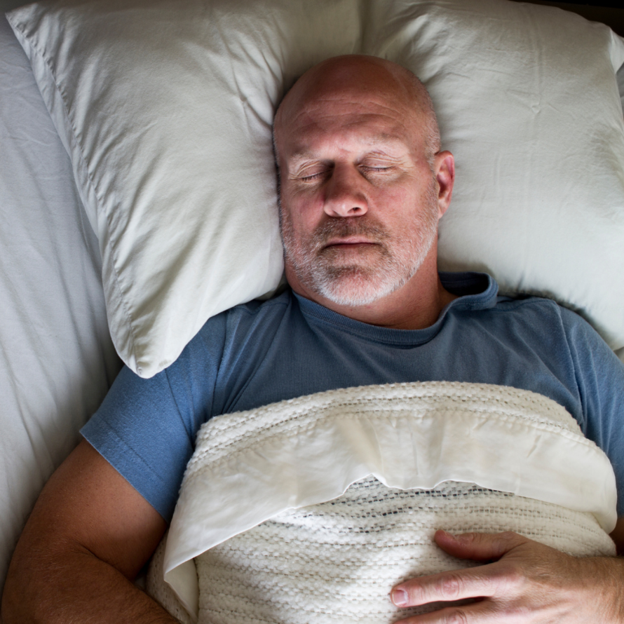 Older man sleeping on his back.