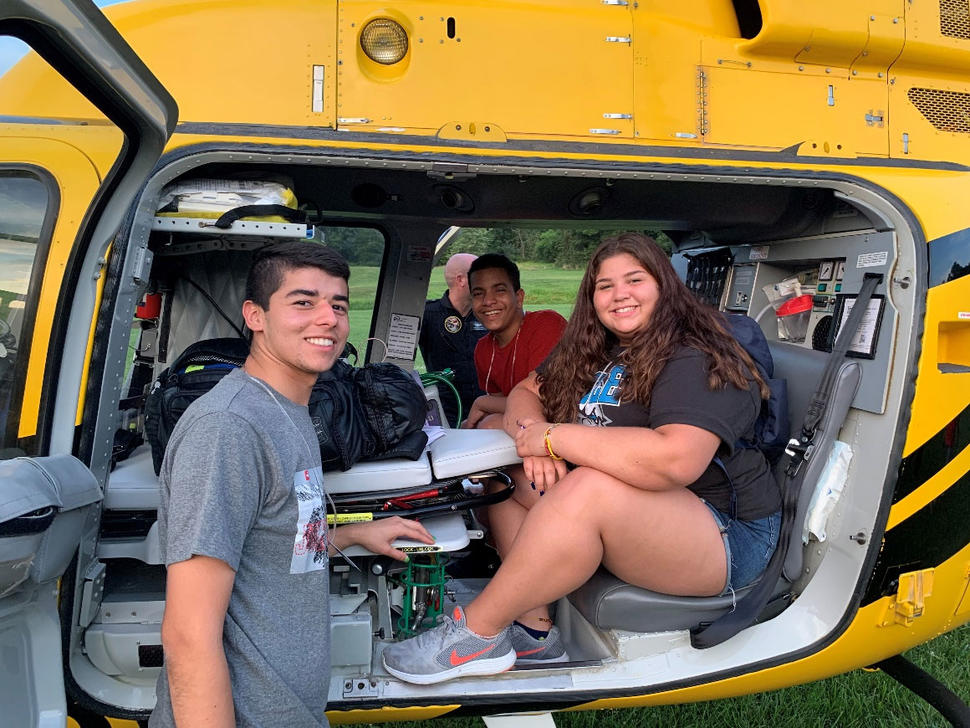 Frank Colon-Matos with campers sitting in a helicopter at Camp Fantastic 2019