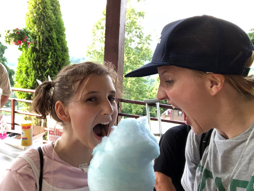 Diana Withrow and camper share cotton candy at Camp Fantastic.