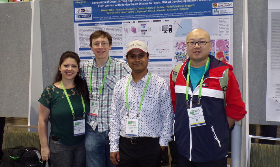 Monjoy Saha, research fellow in the Integrative Tumor Epidemiology Branch, stands in front of his poster with NCI colleagues. From left to right: Aubrey Hubbard, John McElderry, Monjoy Saha, and Jian Sang.
