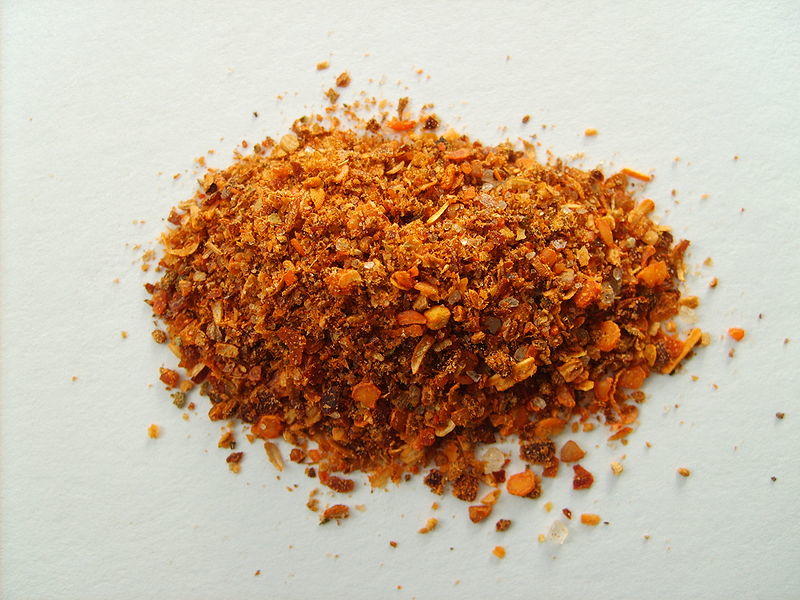 Dark orange mound of Merkén spice blend. 
