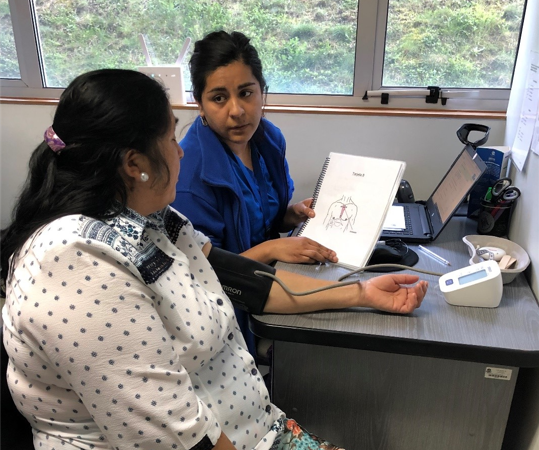 As part of Chile BiLS, a healthcare provider is administering a questionnaire and taking blood pressure of a participant during a second year study visit. 