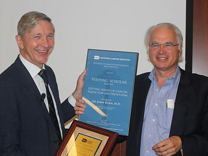 Sir John Burn receives Visiting Scholar plaque from DCEG Director Stephen Chanock to honor his visit to DCEG.