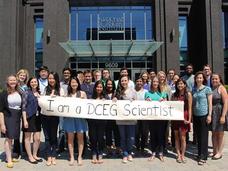 Group of DCEG fellows with banner "I am a DCEG Scientist"