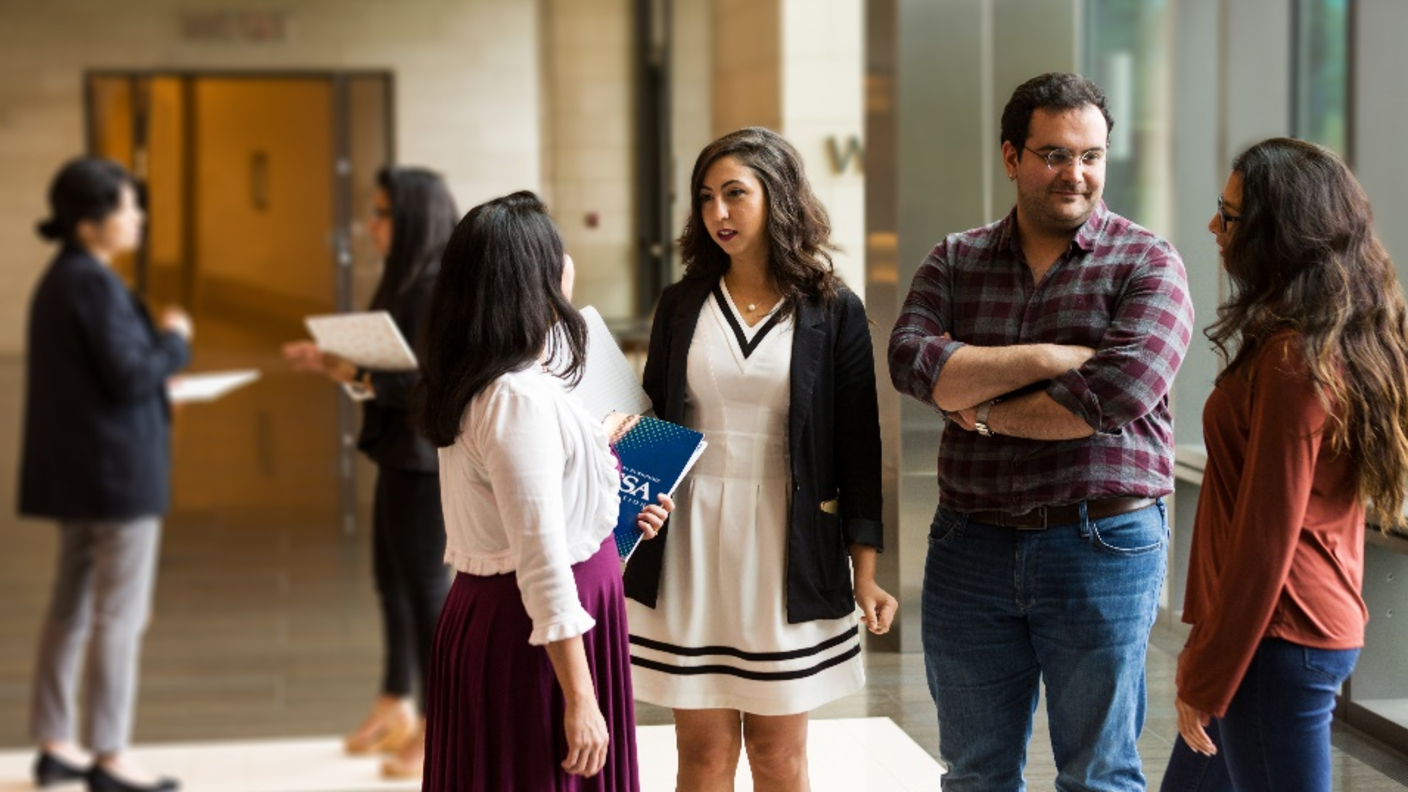 Photo of four fellows talking in a group