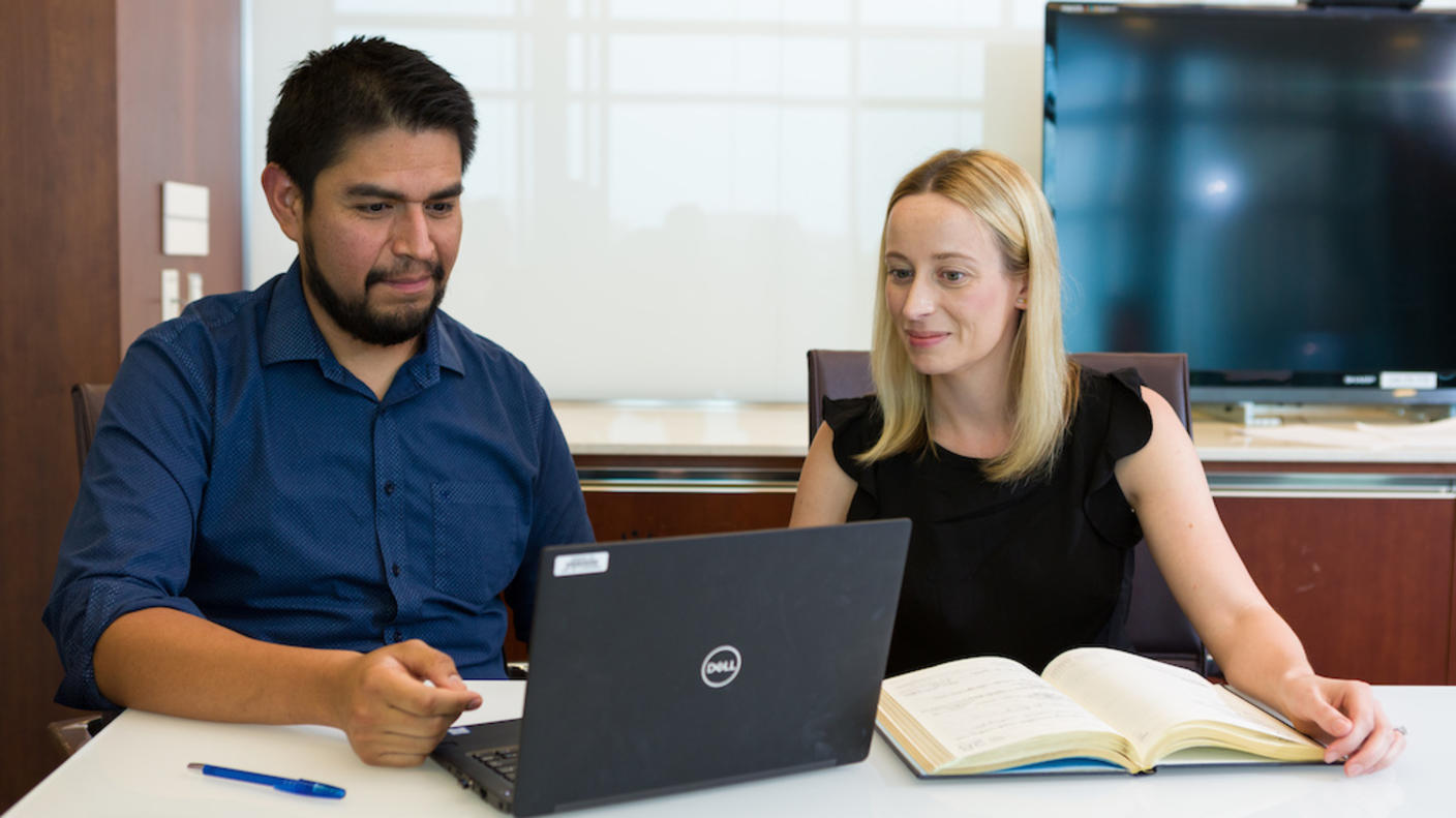 DCEG tenure-track investigators looking at a laptop screen