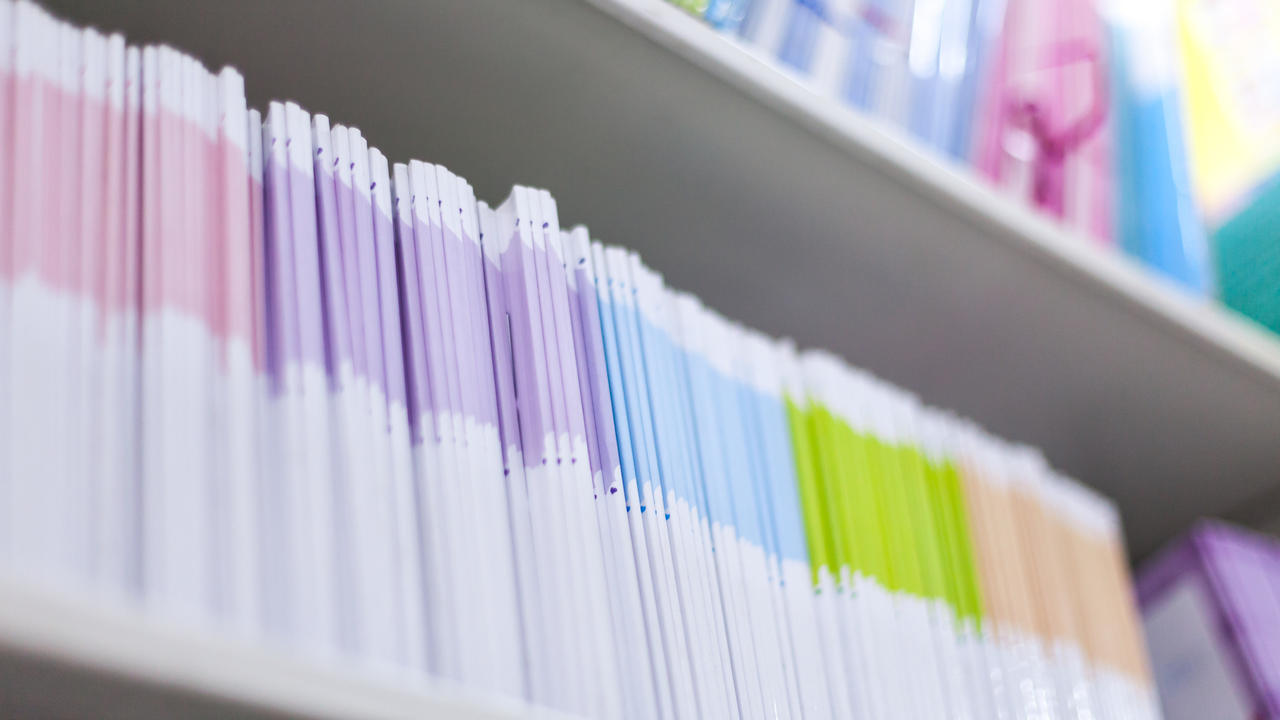 Multiple journals on a shelf. 